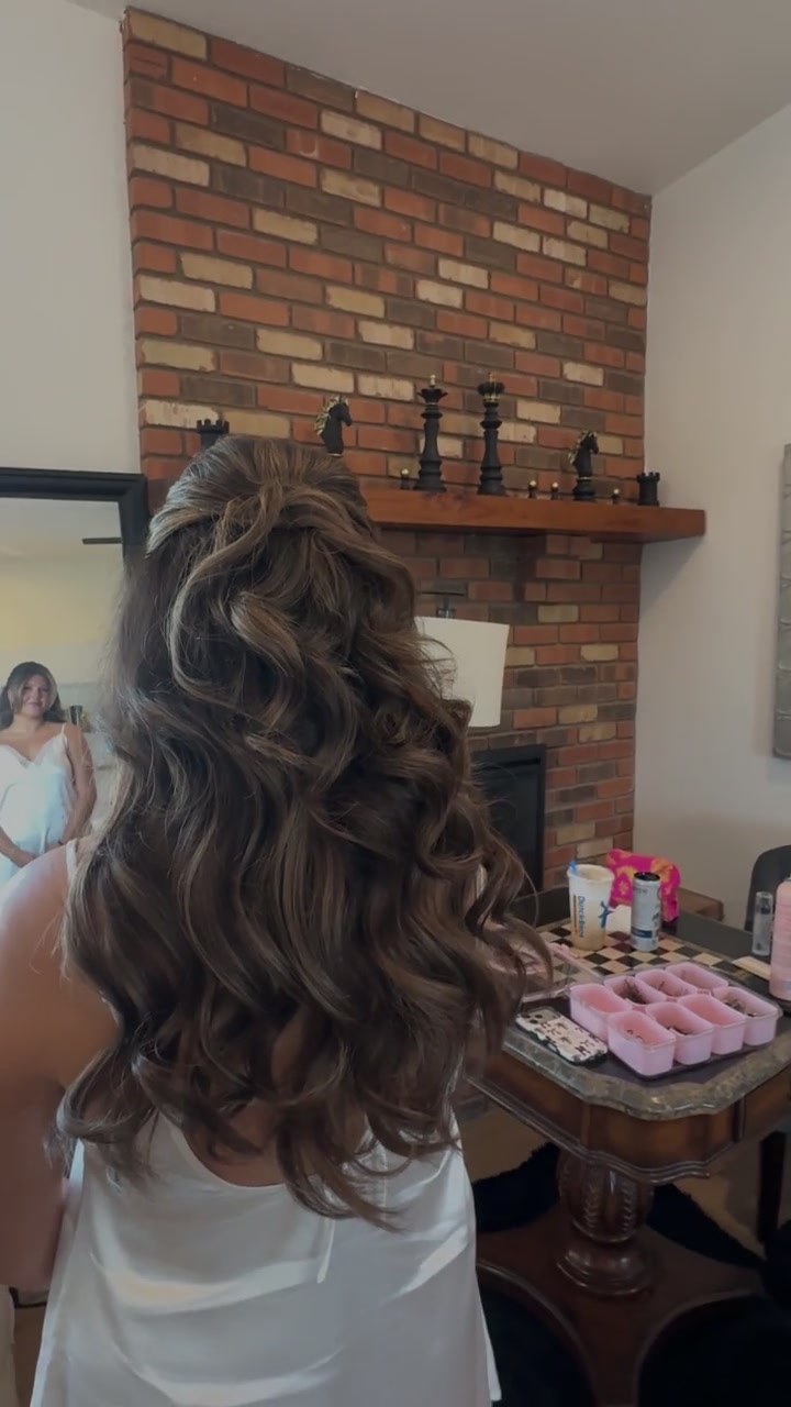 Romantic half-up bridal hairstyle with soft curls for a wedding at The Wright House in Tempe, Arizona